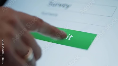 Finger presses submit button on digital survey touchscreen interface