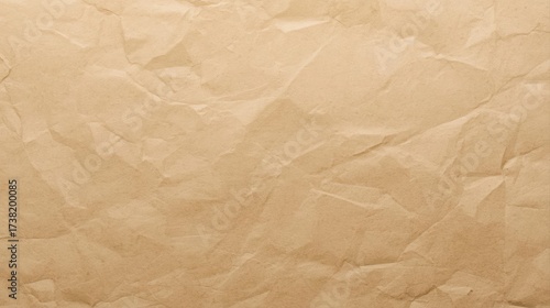 Close up of crinkled craft paper creating an abstract pattern with its brown texture offe a versatile background or artistic surface.