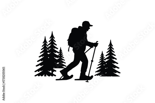 Silhouette of a hiker with snowshoes trekking through a winter forest landscape