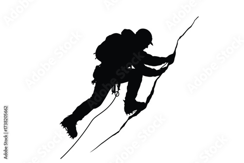 Silhouette of a determined climber ascending a steep rocky surface