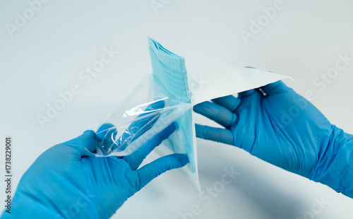 Obraz na plátně Sterile field preparation with gloved hands opening the outer medical packaging