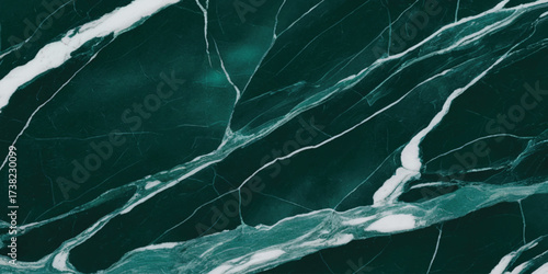 Green marble surface close-up with elegant white veining and organic natural stone texture background.