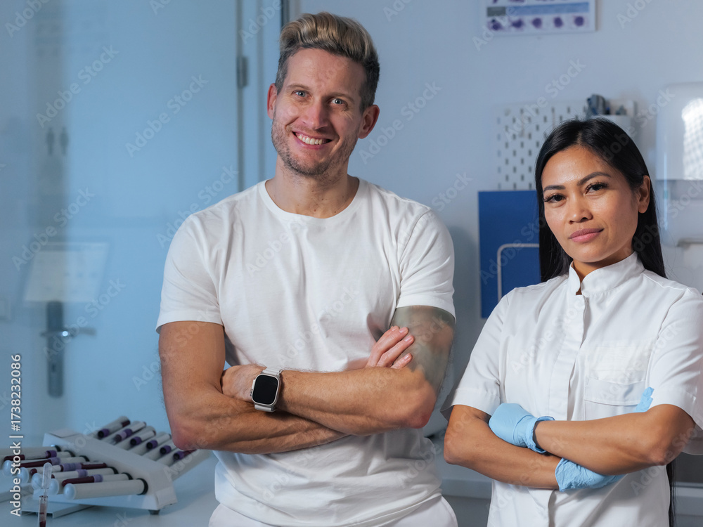 Obraz premium Two healthcare workers stand proudly in a clinic, showcasing their expertise and readiness to assist patients.