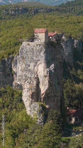 Aerial view of Katskhi Pillar, a monastery built on a tall rock in Georgia. Vertical video