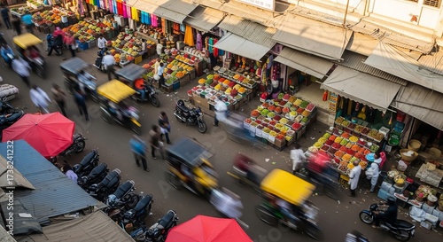Vibrant Indian marketplace bustling with activity captured from above showing colorful stalls and moving vehicles