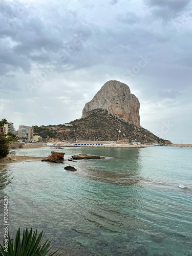 A high cliff juts out into the sea. Seashore. Photo