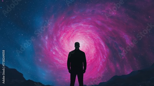 Wallpaper Mural A silhouette of a person stands before a vibrant, swirling galaxy, blending shades of pink and blue, evoking a sense of wonder and cosmic exploration. Torontodigital.ca