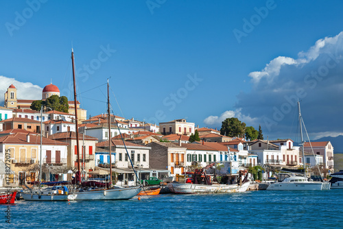 Galaxidi town under tense white clouds, view of the fishing port of this old, traditional village, built by the sea at the Corinthian Gulf, in Greece.