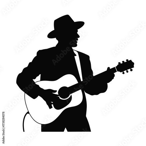 Silhouette of a musician playing an acoustic guitar