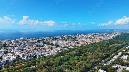 Drone view of the beautiful capital of Latin America. Santo Domingo skyline. City and sea 4K background. Travel and leisure concept. Cityscape panorama with a park during the day.