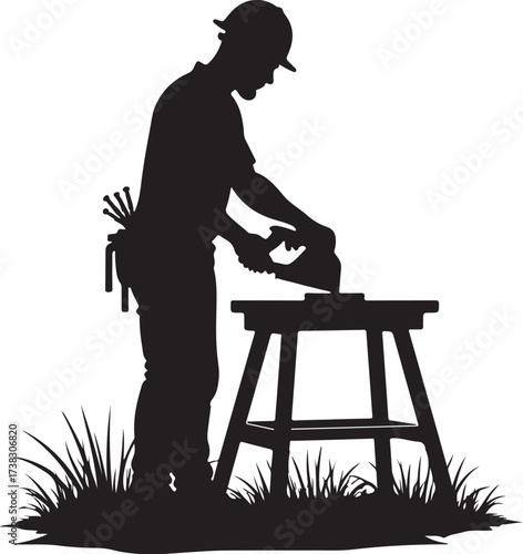 Silhouette of a carpenter using a circular saw on a workbench