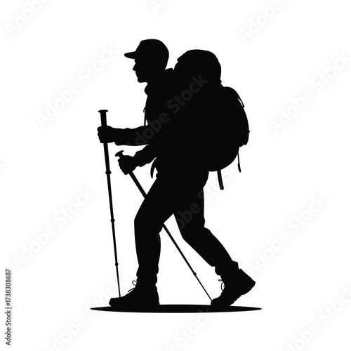 Silhouette of a hiker with backpack and trekking poles walking