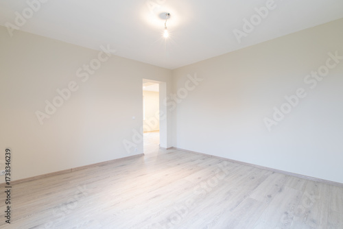 Bright Modern Empty Room With Wooden Flooring and Neutral Interiors. New Construction Home Interior