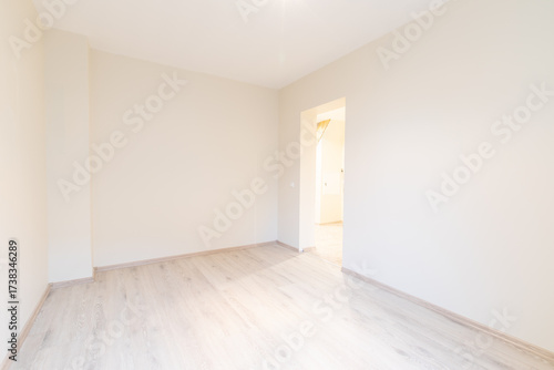 Bright Modern Empty Room With Wooden Flooring and Neutral Interiors. New Construction Home Interior
