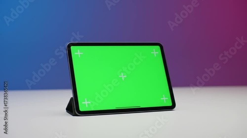 Sleek Digital Tablet with Chroma Key Green Screen on a Vibrant Blue and Purple Gradient Background