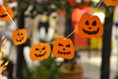 Halloween decor - small painted pumpkins hanging on a string
