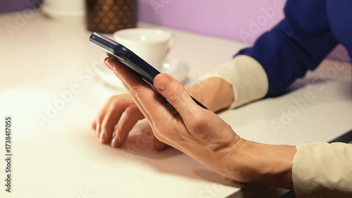 Closeup hands video of business woman holding in hands mobile phone and working, texting, chatting in office. Concept