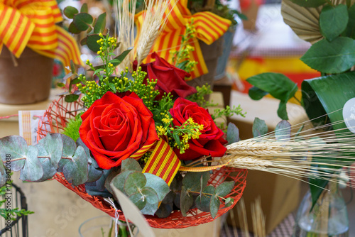 Tableau sur toile Red rose with an ear of wheat, Sant Jordi celebration on April 23rd in Catalonia, Spain