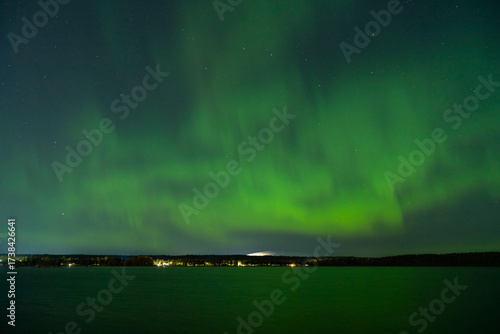 The Northern Lights in the sky over Lake Onega on an autumn night