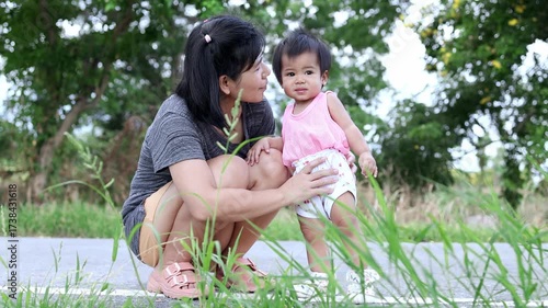mother and baby spending time together outdoors, mother and baby playing happily, happy mom and baby activities, representing love, warmth, and strong family bond