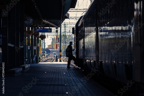 Silhouette of man boarding train at railway station
