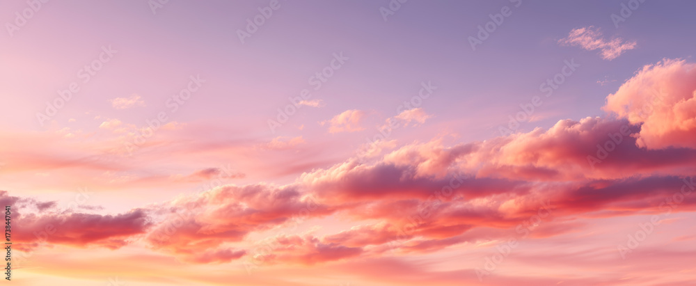 Obraz premium Dreamy sky filled with soft pink clouds during a vibrant sunset