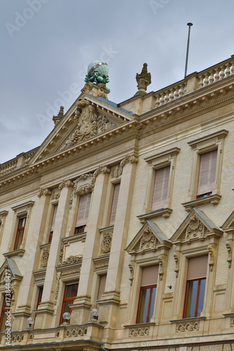 a building with a sculpture on a cloudy day
