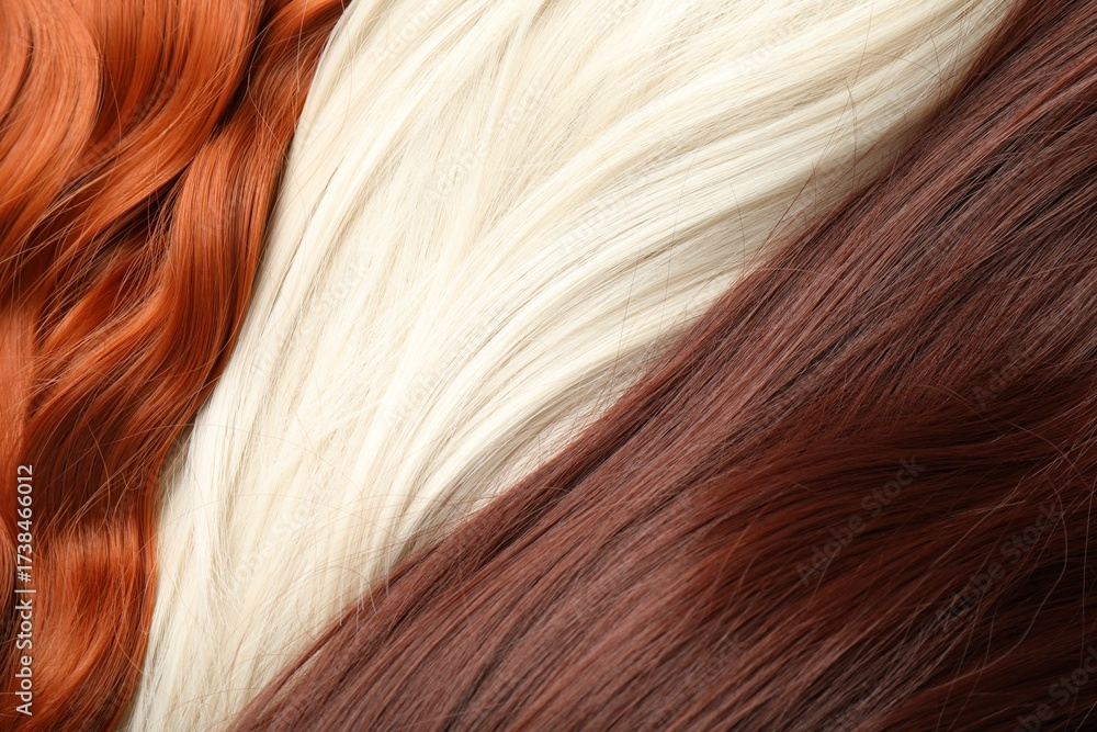 Naklejka premium Strands of different beautiful hair as background, top view