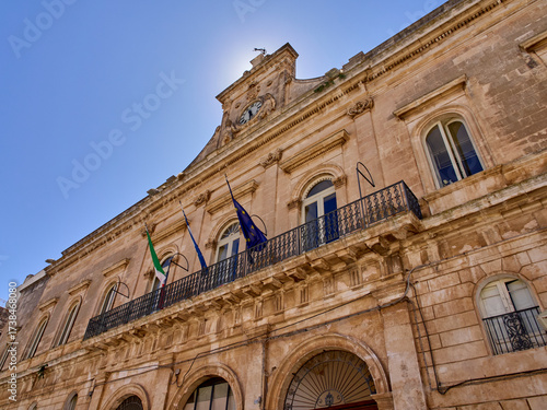 Ostuni, Italy - July 30, 2025: Palazzo Municipale, originally a Franciscan monastery, is the building of the Town Hall. Piazza della Libertá, Ostuni, The White City, Puglia, Italy, Europe