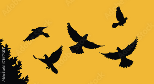 Silhouette of a flock of birds in flight against a golden sky.