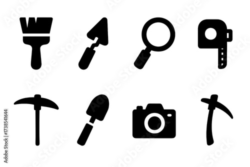 Archaeological Tools Icons. Solid, filled icon set of archaeological tools: brush, trowel, magnifying glass, measuring tape, compass, pickaxe, shovel, camera.