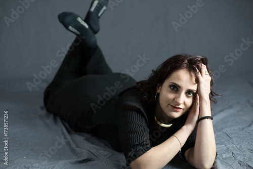 brunette model poses sensually in a photo studio for a fashion magazine
