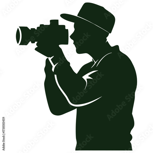 Silhouette of a person wearing a hat holding and operating a video camera