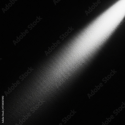 A beam of light shining on a dark wall, creating a stark contrast.