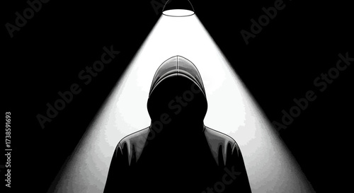 Mysterious hooded figure in dramatic spotlight and shadow play