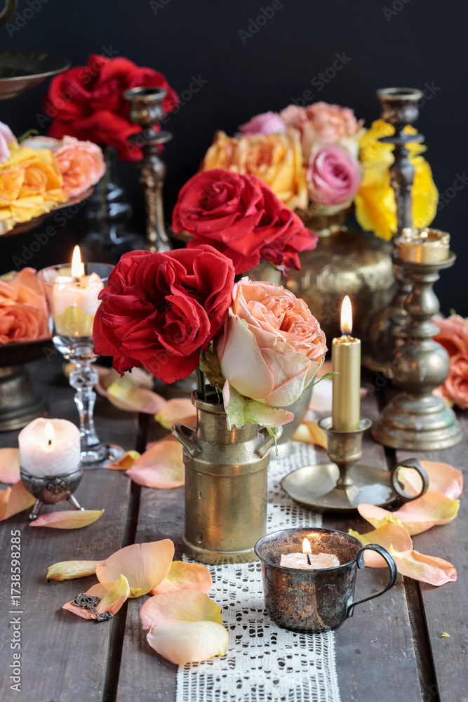 Fototapeta premium Romantic table decoration with roses and candles. Valentine's Day decorating ideas.