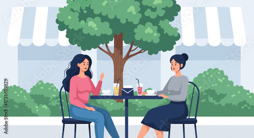 Two women enjoying a delightful outdoor cafe conversation under a large shady tree on a pleasant day