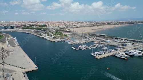 Aerial drone view of Real Juan Carlos Marina in Valencia with parks and nearby Las Arenas beach. Valencia, Spain