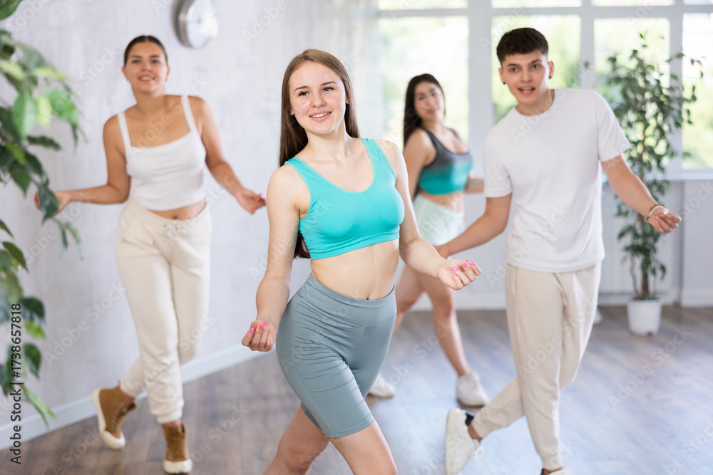 Fototapeta premium Active teenagers dancing modern dances in a modern studio