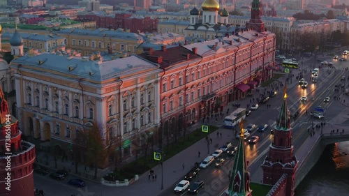 Aerial video captures a historic cityscape at sunset, highlighting ornate architecture and bustling streets from a high angle perspective.