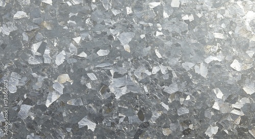 Cool-toned industrial metal wallpaper. Abstract background texture of galvanized steel with a reflective, geometric crystal spangle pattern for design