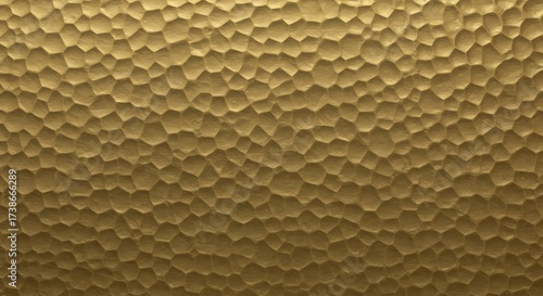 Luxurious hammered gold metal texture. Detailed background of a beaten brass surface with an irregular polygonal pattern, ideal for elegant design projects