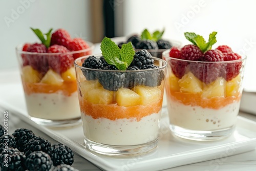 Layering fruit parfait with fresh berries and yogurt