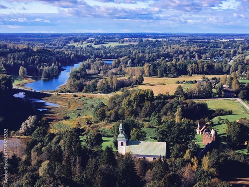 Karksi, Estonia September 25, 2025: South Estonian landscape with the historic Karksi Lutheran Church, castle ruins, and a winding river surrounded by forests and fields