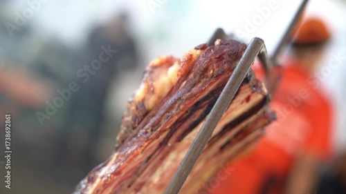 whole rib roasted on the barbecue on the ground