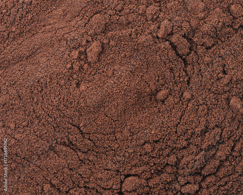 Close-up texture of ground coffee, brown powder background with rich aroma and fine particles, perfect for espresso and brewing concepts.