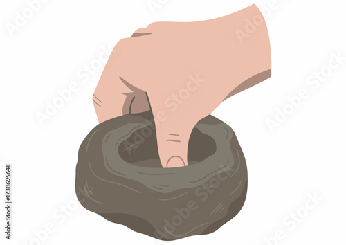 A hand shaping clay, forming a small bowl-like structure with fingers.