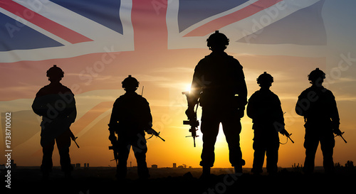 Silhouettes of british soldiers standing in formation against a vibrant sunset with the union jack flag overhead