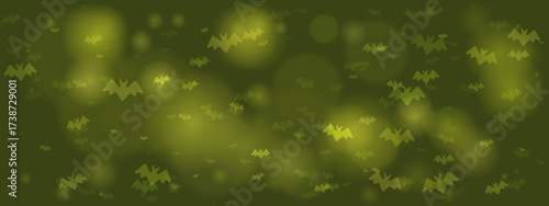 Abstract green background with flying bat silhouettes and glowing bokeh effects, perfect for Halloween or spooky themes.