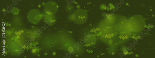 Green Halloween background with flying bat silhouettes and glowing bokeh lights, creating a spooky and mysterious festive atmosphere.